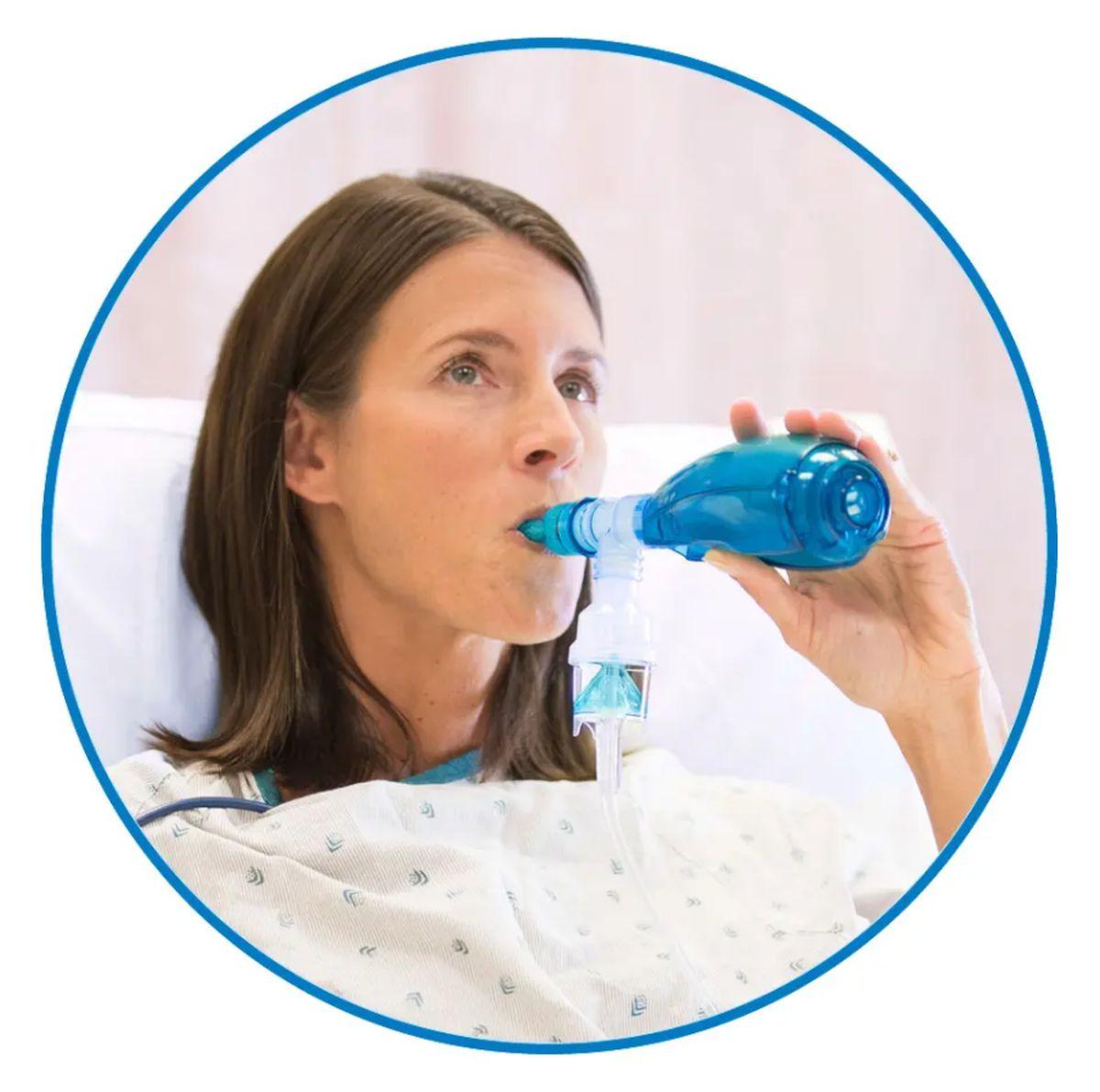 Woman using an Acapella Breathing Device in Boynton Beach, FL 
